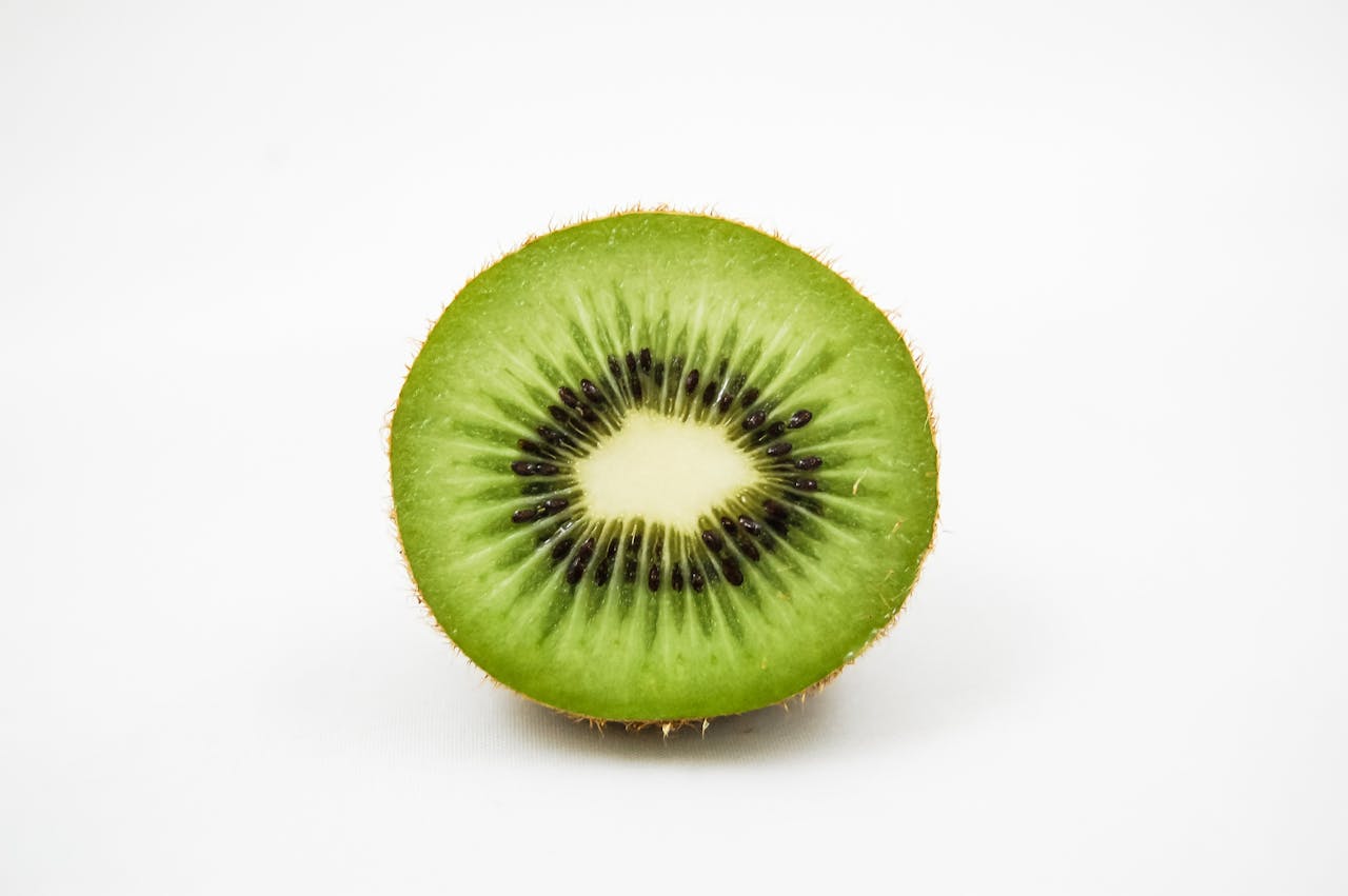 Close-up of a fresh kiwi fruit slice showcasing its vibrant green and black seeds.
