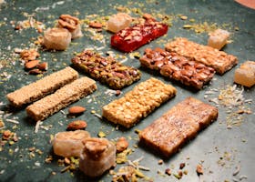 pexels photo 12428388 12428388 A variety of nut and seed bars showcasing delicious textures and flavors.