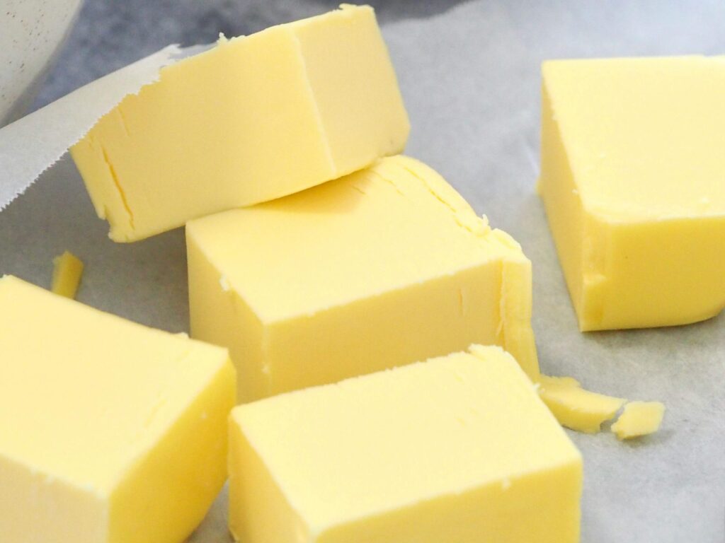 pexels photo 4182680 4182680 Butter cubes and flour in bowls on a marble counter for baking preparation.