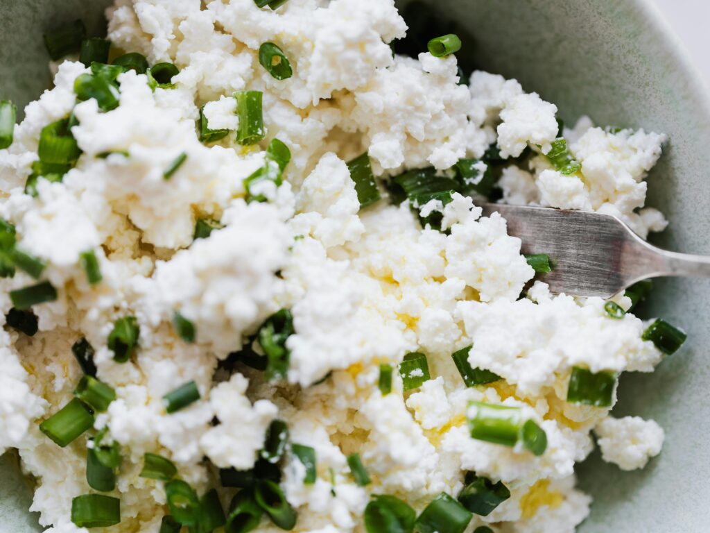 pexels photo 4198140 4198140 Top view of gray bowl with meal cottage cheese with pieces of green onion and fork placed on kitchen meal for breakfast